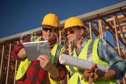 Male and Female Construction Workers Using Computer Pad at Const