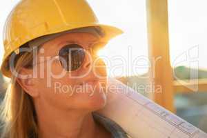 Female Construction Worker with House Plans at Construction Site