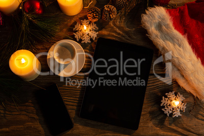 digital tablet and smartphone with Christmas ornament