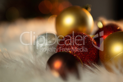 Colored Christmas ornaments on a carpet