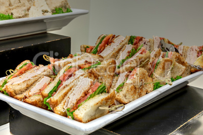 Turkey club sandwich made with turkey, tomato, bacon, mayo and l