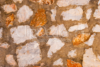 roughly made wall of natural granite stones