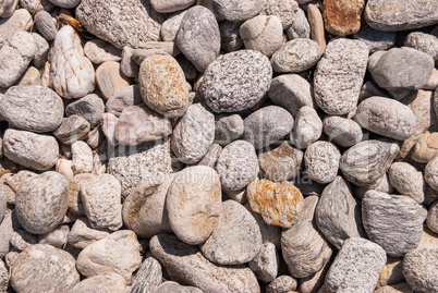Gray pebbles on the coast pile of sea stones and stones on the beach