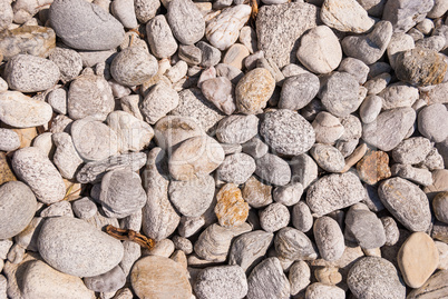 Gray pebbles on the coast pile of sea stones and stones on the beach