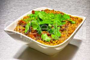 Moong Dahl, indian vegetarian lentil soup in white bowl.