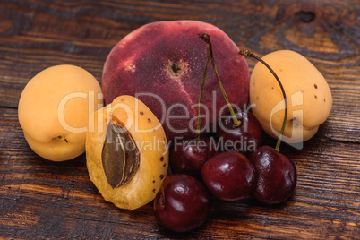 Ripe and sweet fruits on dark wooden background