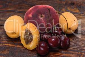Ripe and sweet fruits on dark wooden background