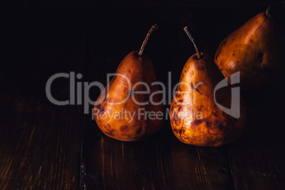 Golden Pears on Wooden Table