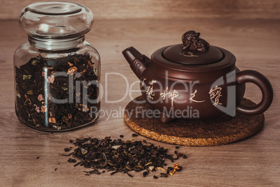 Asian teapot and jar with tea