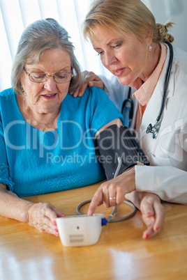 Senior Adult Woman Learning From Female Doctor to Use Blood Pressure Machine