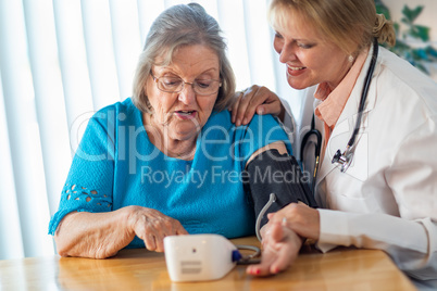 Senior Adult Woman Learning From Female Doctor to Use Blood Pressure Machine