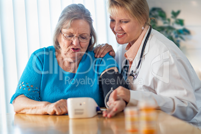 Senior Adult Woman Learning From Female Doctor to Use Blood Pressure Machine