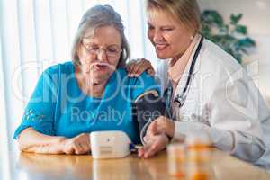 Senior Adult Woman Learning From Female Doctor to Use Blood Pressure Machine