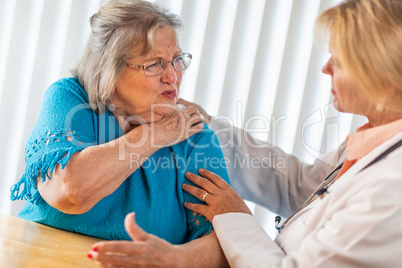 Senior Adult Woman Talking with Female Doctor About Shoulder Pain