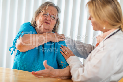 Senior Adult Woman Talking with Female Doctor About Sore Shoulder
