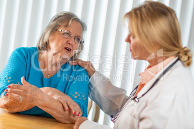 Senior Adult Woman Talking with Female Doctor About Sore Arm