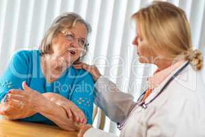 Senior Adult Woman Talking with Female Doctor About Sore Arm