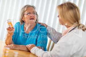 Female Doctor Talking with Senior Adult Woman About Medicine Pre