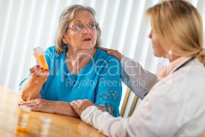 Female Doctor Talking with Senior Adult Woman About Medicine Pre