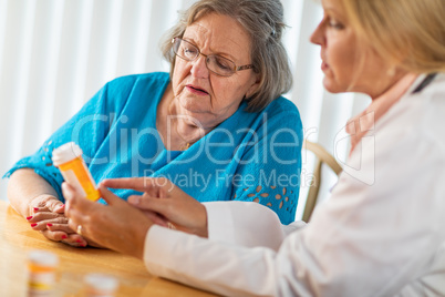 Female Doctor Talking with Senior Adult Woman About Medicine Pre