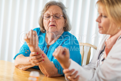 Female Doctor Talking with Senior Adult Woman About Hand Therapy