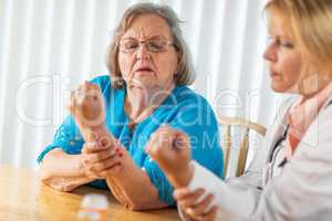 Female Doctor Talking with Senior Adult Woman About Hand Therapy