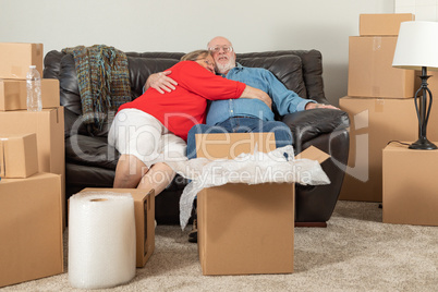 Affectionate Tired Senior Adult Couple Resting on Couch Surround