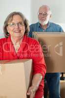 Senior Adult Couple Carrying Moving Boxes