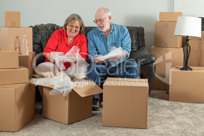 Senior Adult Couple Packing or Unpacking Moving Boxes