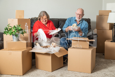 Senior Adult Couple Packing or Unpacking Moving Boxes