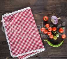 red textile kitchen towel in a cage and fresh cherry tomatoes