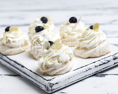 small baked round cake meringue with whipped cream