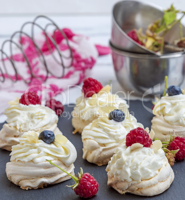 small baked round meringues with whipped cream
