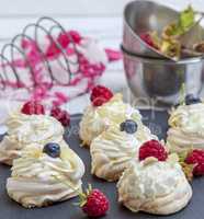 small baked round meringues with whipped cream