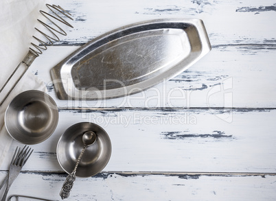 kitchen empty metal objects on a white wooden background