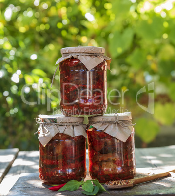 three glass jars with canned aubergines