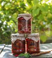 three glass jars with canned aubergines