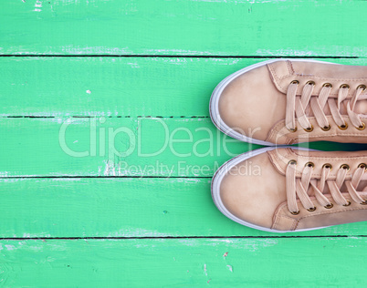 top view of a pink pair of female leather sneakers