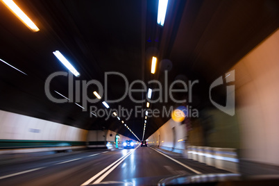 Motion Blur Driving Car at Speed Through a Tunnel at Night