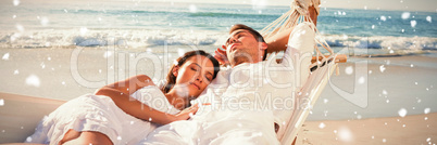 Composite image of calm couple napping in a hammock