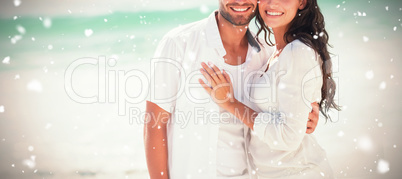 Composite image of happy couple looking at camera