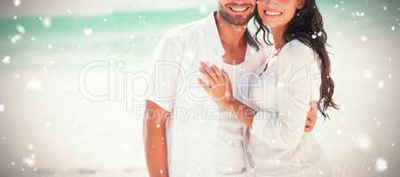 Composite image of happy couple looking at camera