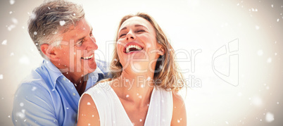 Composite image of happy couple laughing together