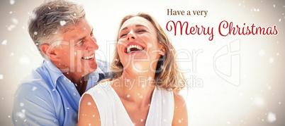 Composite image of happy couple laughing together