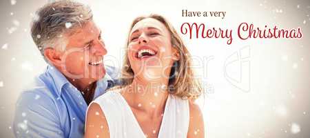 Composite image of happy couple laughing together