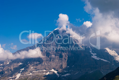 view of the Northern wall of Eiger in the clouds. Bernese Oberland, Switzerland