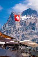 Beautiful view of the Wetterhorn peak and the Swiss flag, Grindelwald Switzerland