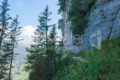 Hiking trail in the Swiss Alps in summer overlooking the Eastern slopes of the Eiger peak