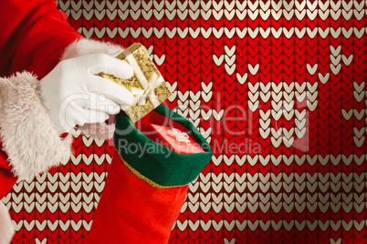 Composite image of santa claus putting presents in christmas stockings