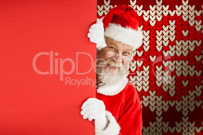Composite image of santa claus peeking from red board